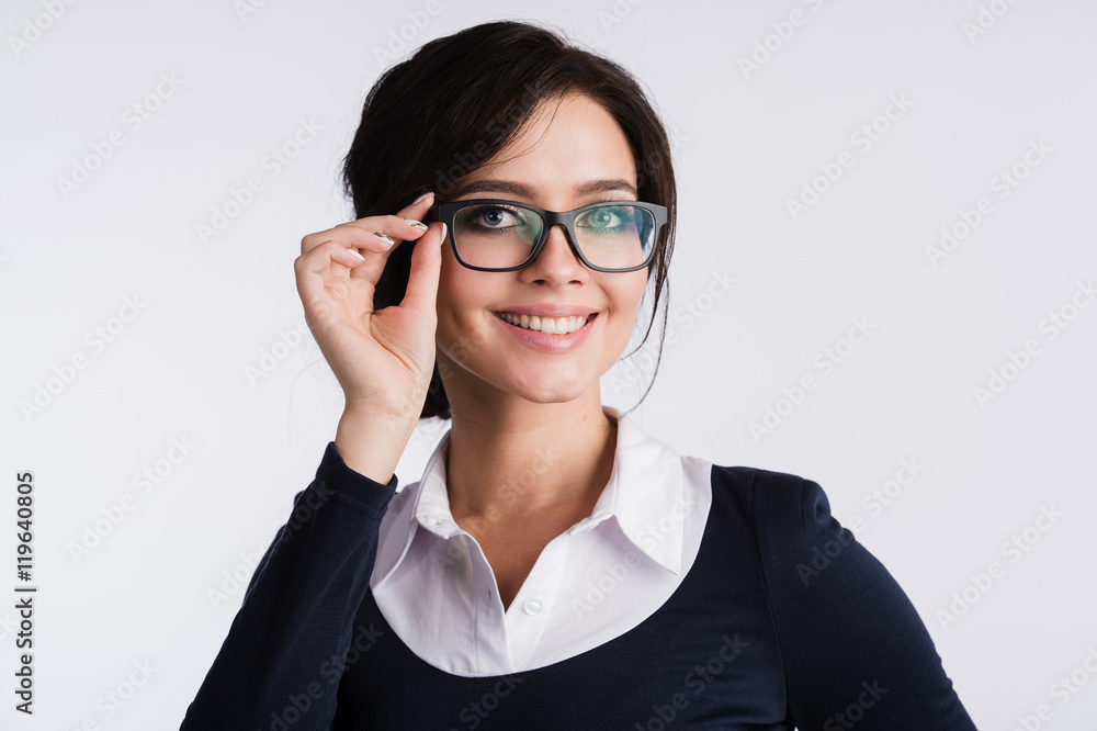 Young attractive happy woman trying on new glasses