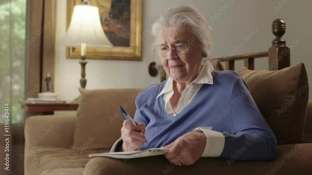 A senior elderly woman on a couch suffers dementia or Alzheimer's and can't remember something. Shot in 4K UHD. A senior elderly woman on a couch suffers dementia or Alzheimer's and can't remember something. Shot in 4K UHD.