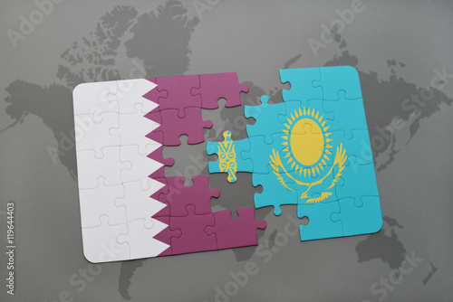 puzzle with the national flag of qatar and kazakhstan on a world map background.