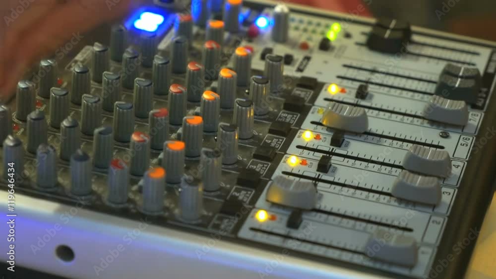 DJ working on a audiomixer at a nightclub DJ working on a audiomixer at a nightclub