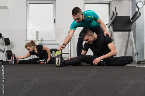 People Stretching During Fitness Class In Fitness Center