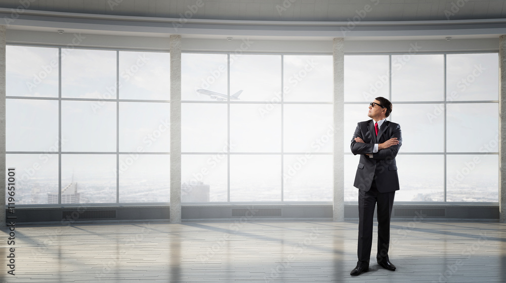 Businessman in empty office . Mixed media Businessman in empty office . Mixed media