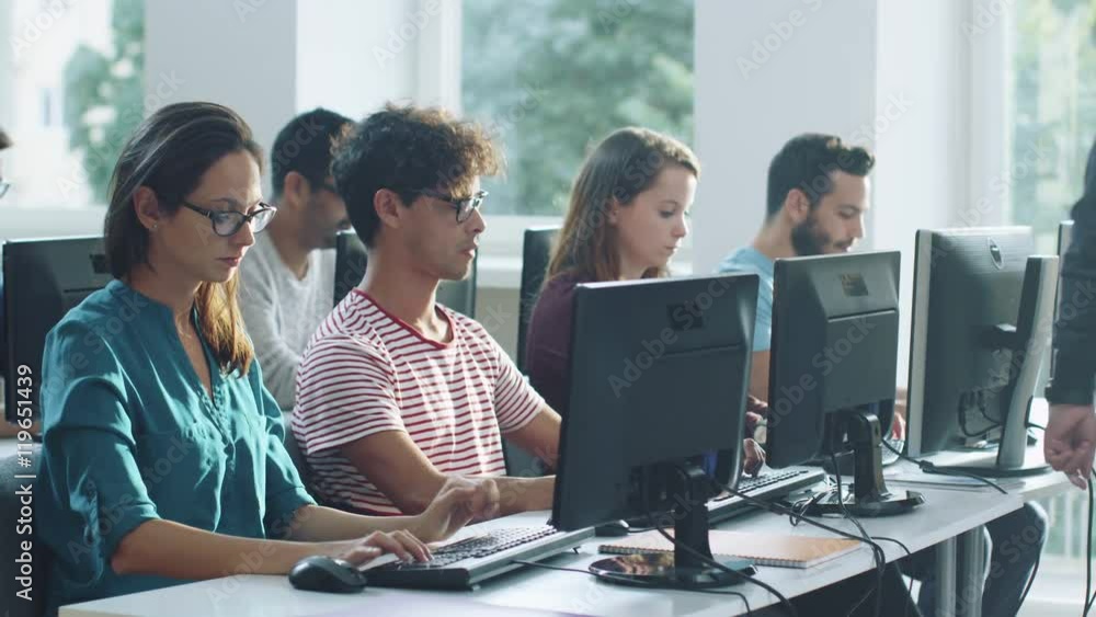 Group of Mixed Race Students on Lecture in Computer Class. Shot on RED Cinema Camera in 4K (UHD). Group of Mixed Race Students on Lecture in Computer Class. Shot on RED Cinema Camera in 4K (UHD).