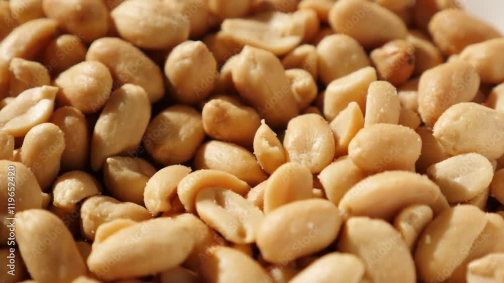 In a bowl served tasty groundnut snack food slow tilting background 4K 2160p UltraHD video - Salted and roasted snack Arachis hypogaea peanuts pile 4K 3840X2160 UHD tilt footage In a bowl served tasty groundnut snack food slow tilting background 4K 2160p UltraHD video - Salted and roasted snack Arachis hypogaea peanuts pile 4K 3840X2160 UHD tilt footage