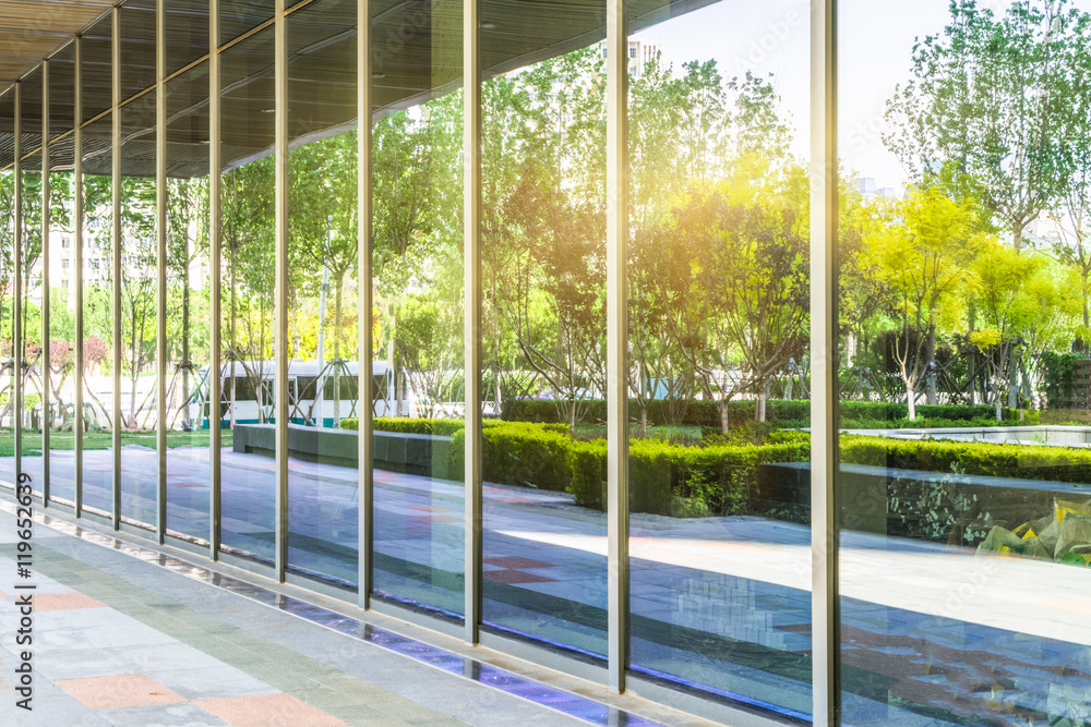 trees and blue sky reflected on clean glass wall,china. trees and blue sky reflected on clean glass wall,china.