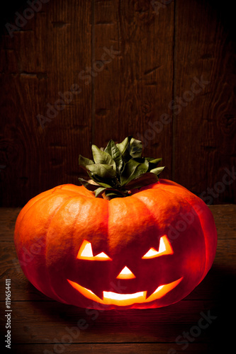 Scary Halloween pumpkin on a old wooden background