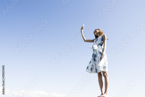Blue sky, woman, smartphone