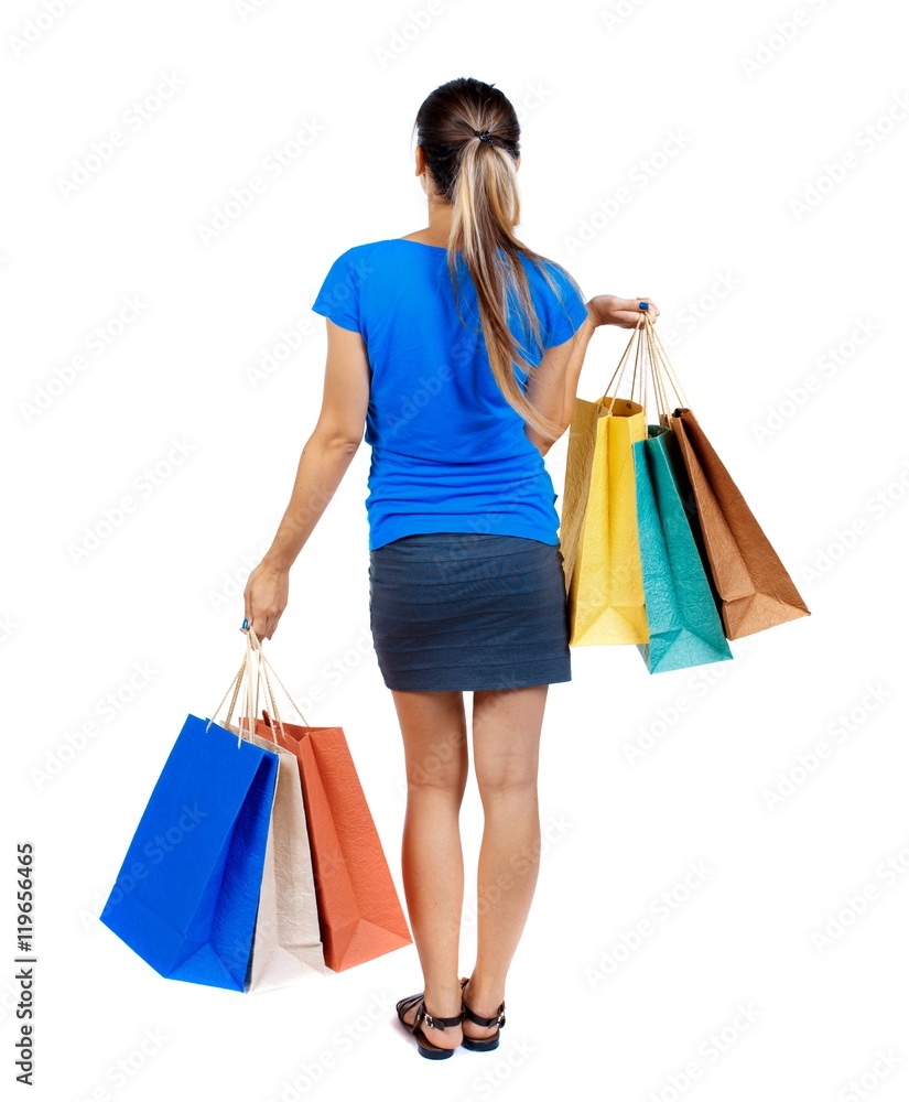 back view of woman with shopping bags. backside view of person. Isolated over white background.