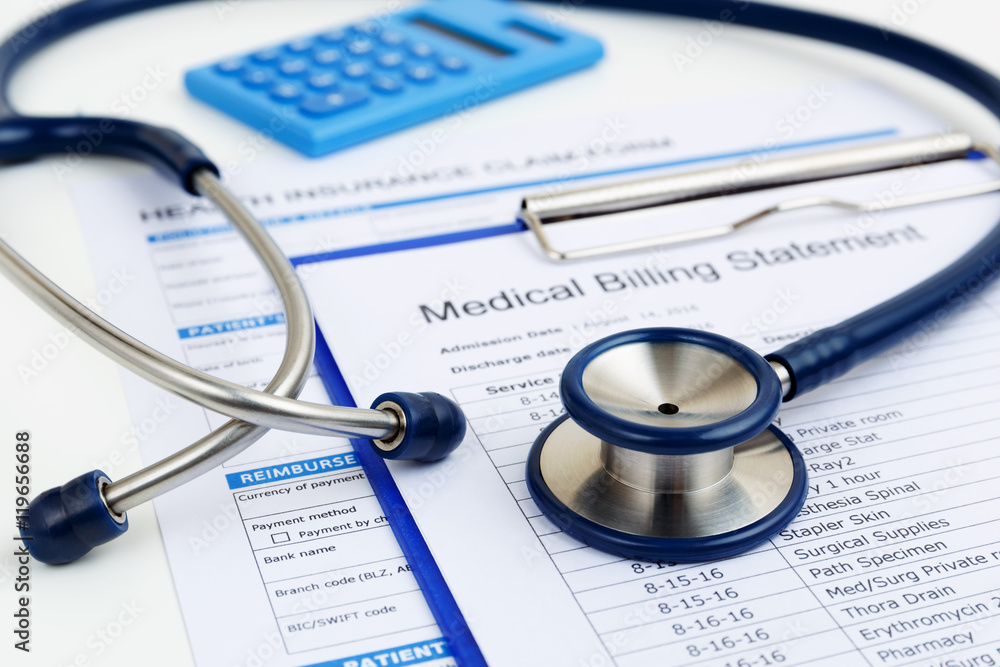 Stethoscope on medical bills and health insurance claim form Stethoscope on medical bills and health insurance claim form