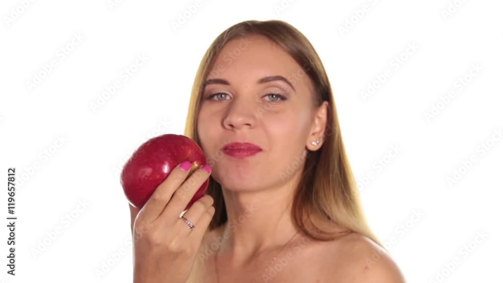 naked young woman wears red lipstick and has her hair down, and brushed, eating a big, dark red apple. healthy food - strong teeth concept. On a white background naked young woman wears red lipstick and has her hair down, and brushed, eating a big, dark red apple. healthy food - strong teeth concept. On a white background