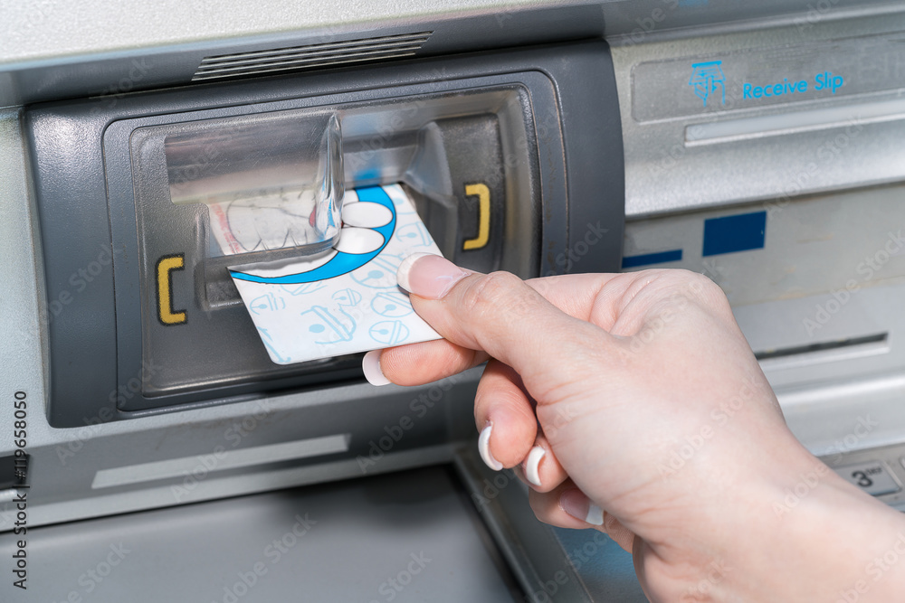 Hand inserting ATM card into bank machine to withdraw money
Hand inserting ATM card into bank machine to withdraw money