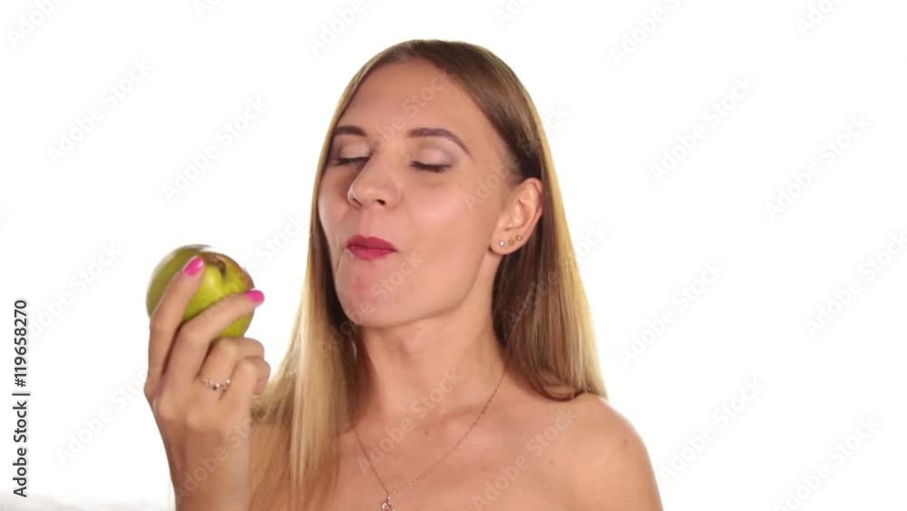 naked young woman wears red lipstick and has her hair down, and brushed, eating a big, juicy pear. healthy food - strong teeth concept. On a white background naked young woman wears red lipstick and has her hair down, and brushed, eating a big, juicy pear. healthy food - strong teeth concept. On a white background