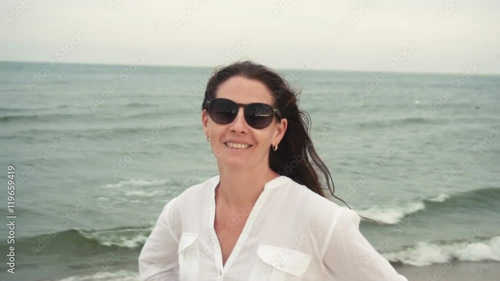 Attractive girl on the seacoast in sunglasses Attractive girl on the seacoast in sunglasses