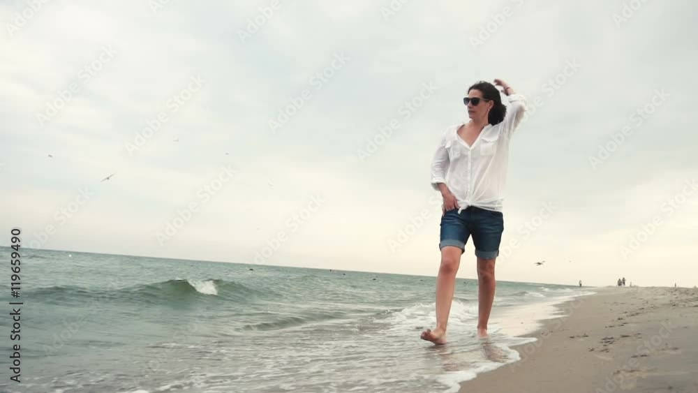 Attractive girl on the seacoast in sunglasses Attractive girl on the seacoast in sunglasses