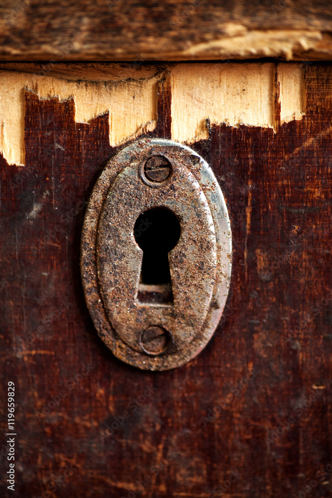 Rusty keyhole in old wooden table
