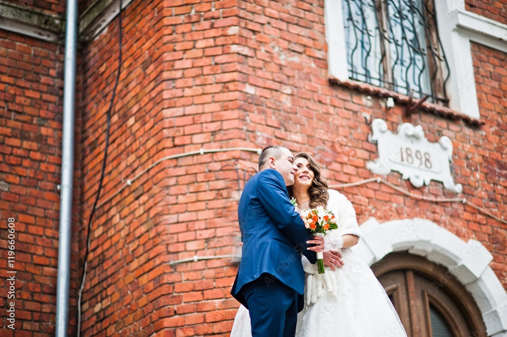 Wedding couple in love bacground old brick house