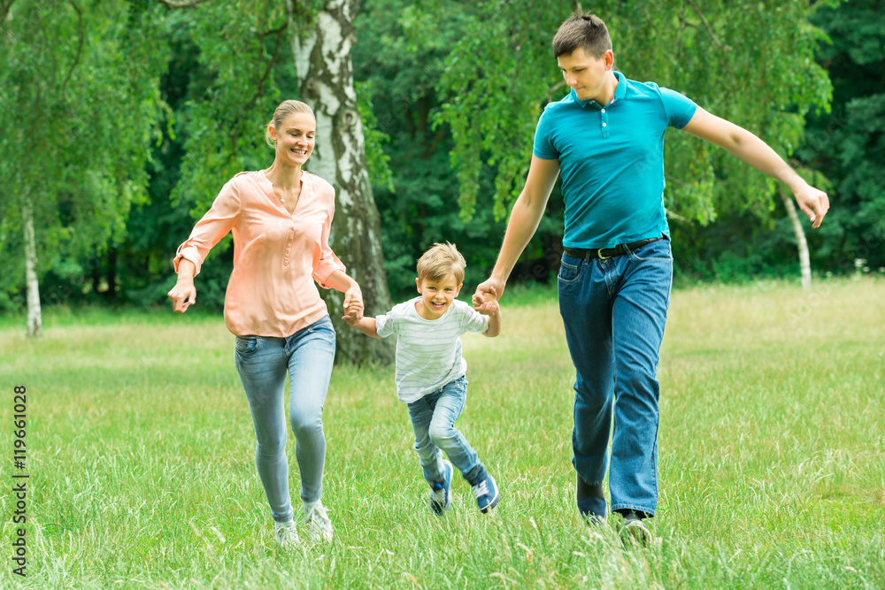 Fototapeta premium Family Running In The Park