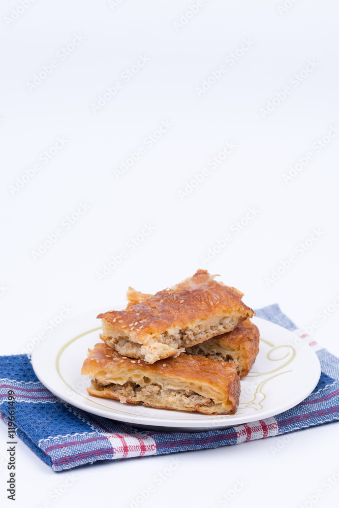 Homemade burek with minced meat over white background