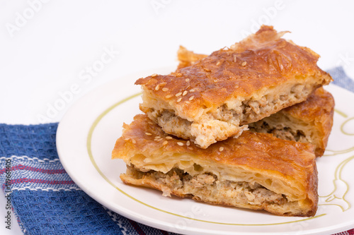 Homemade meat pie on the plate over white background