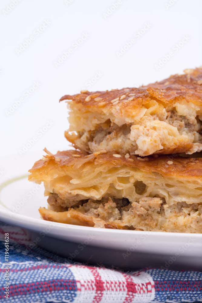 Homemade burek with minced meat over white background Homemade burek with minced meat over white background