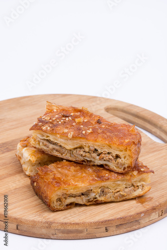 Homemade meat pie over white background