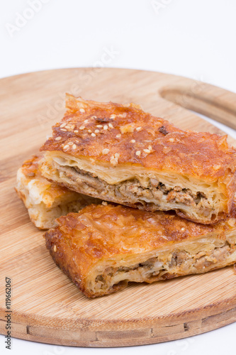 Homemade meat pie over white background