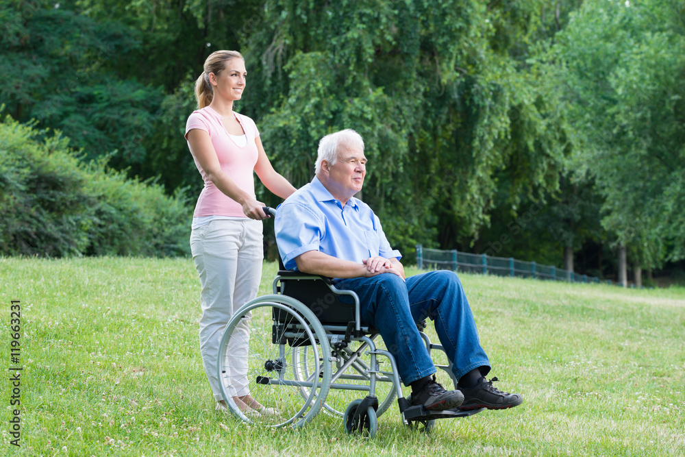Woman With Her Disabled Father On Wheelchair Woman With Her Disabled Father On Wheelchair