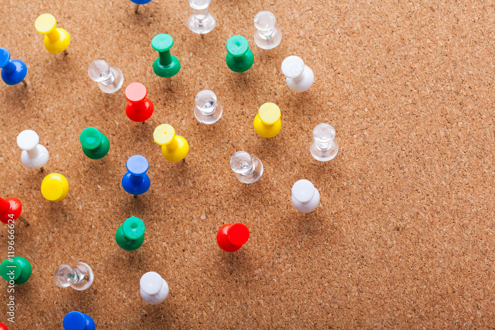 Group of thumbtacks pinned on corkboard Group of thumbtacks pinned on corkboard