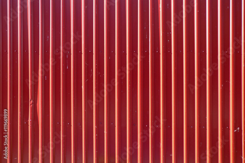 Red long goffered metal texture, corrugated steel photo