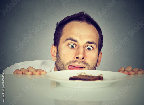 Hungry man craving sweet food photo