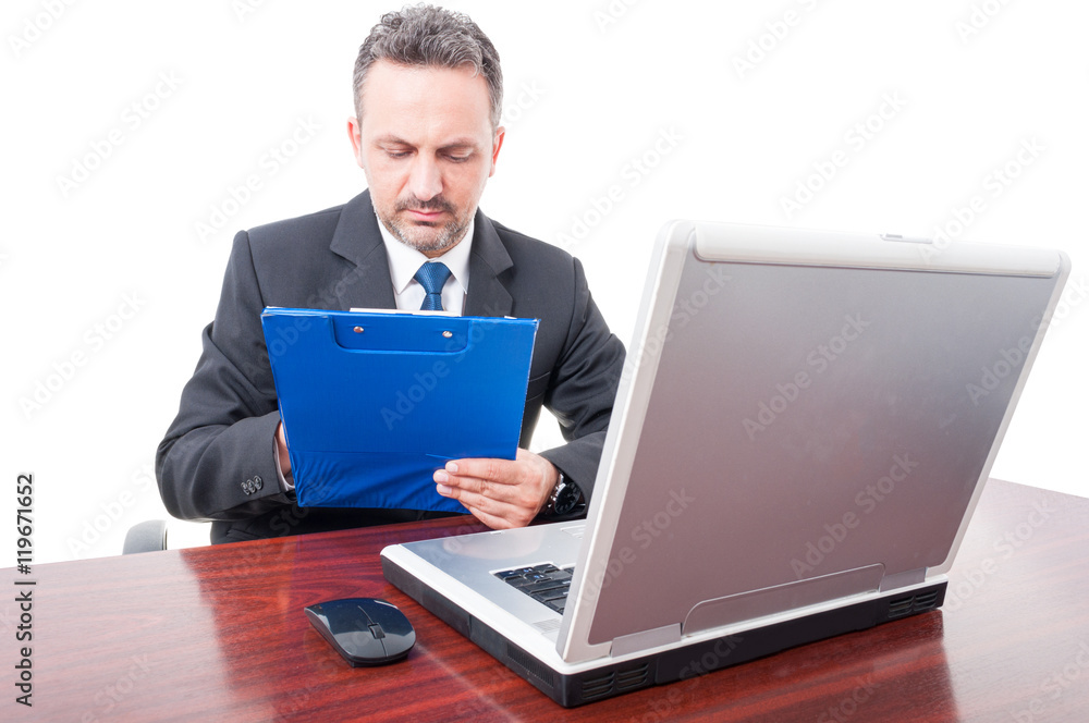 Successful businessman reading the checklist on clipboard Successful businessman reading the checklist on clipboard