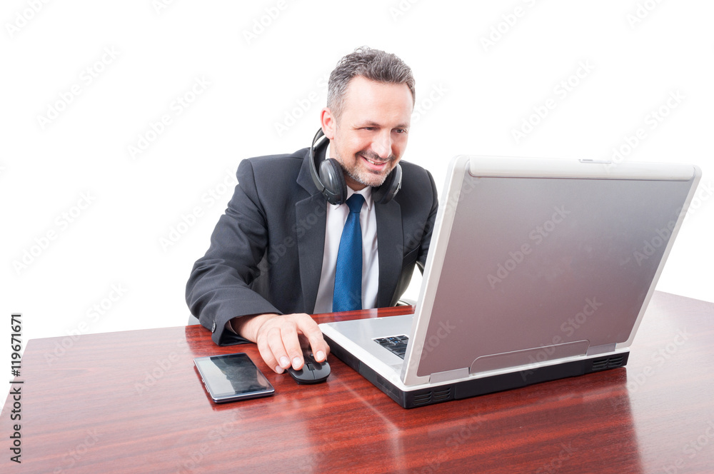 Relaxed broker wearing earphones around neck Relaxed broker wearing earphones around neck