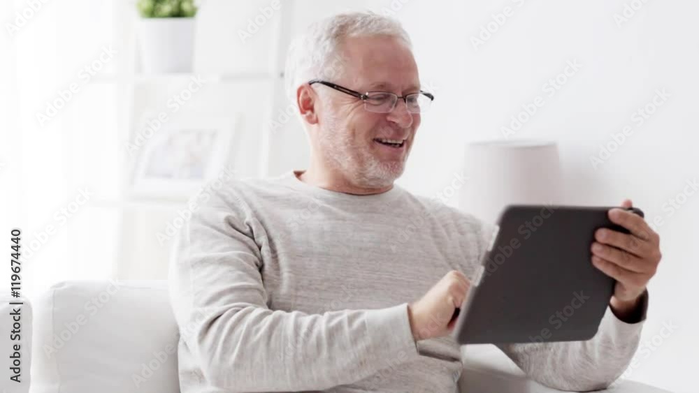 senior man having video call on tablet pc at home 86 senior man having video call on tablet pc at home 86