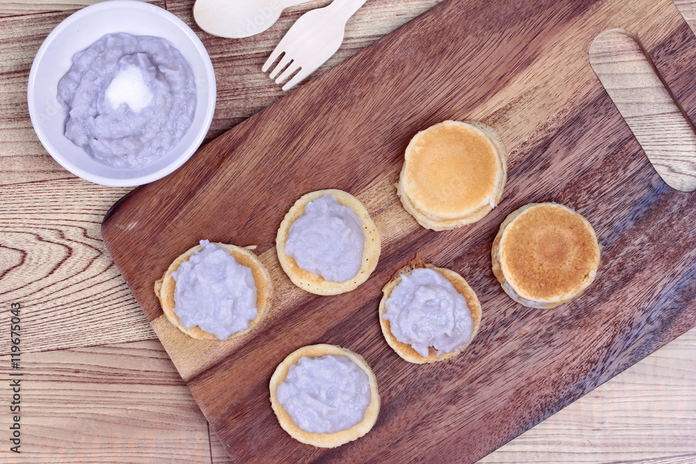 Mini pancake topped stirred taro on wood. Mini pancake topped stirred taro on wood.