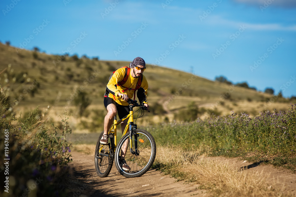 Mountain Bike cyclist riding single track above sunset valley Mountain Bike cyclist riding single track above sunset valley