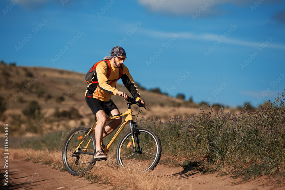 Mountain Bike cyclist riding single track above sunset valley Mountain Bike cyclist riding single track above sunset valley