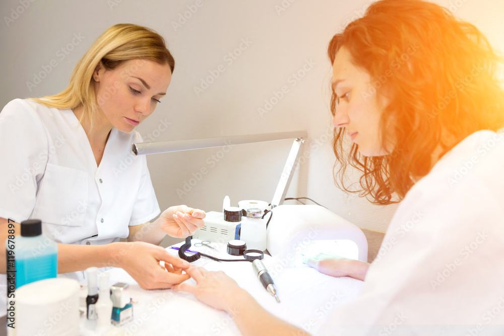 Fototapeta premium Young attractive beautician students practising during courses