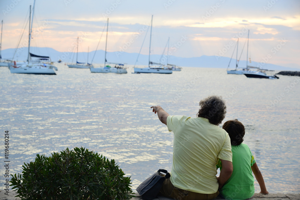 Father and son showing him the sea and yachts Father and son showing him the sea and yachts