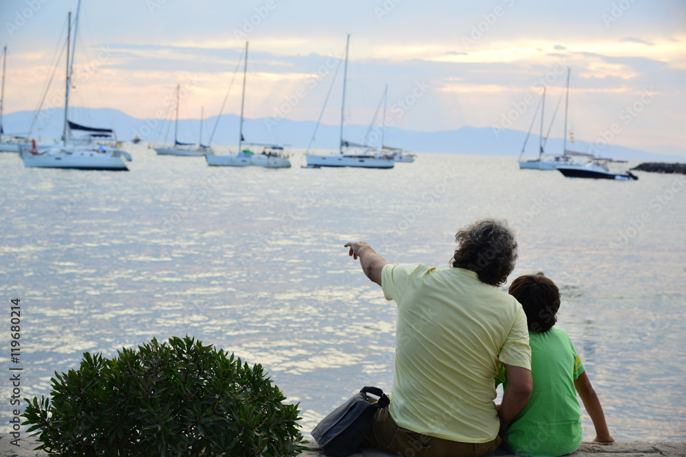 Father and son showing him the sea and yachts