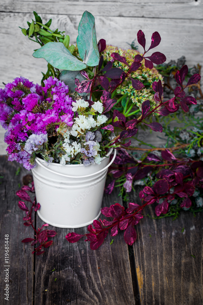 little white bucket with flowers