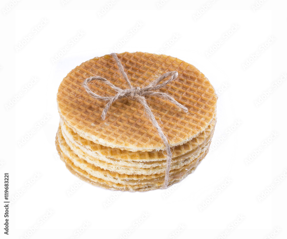 Stack of Dutch caramel waffles. Streak of Traditional Dutch waffle called Stroopwafel tied isolate.