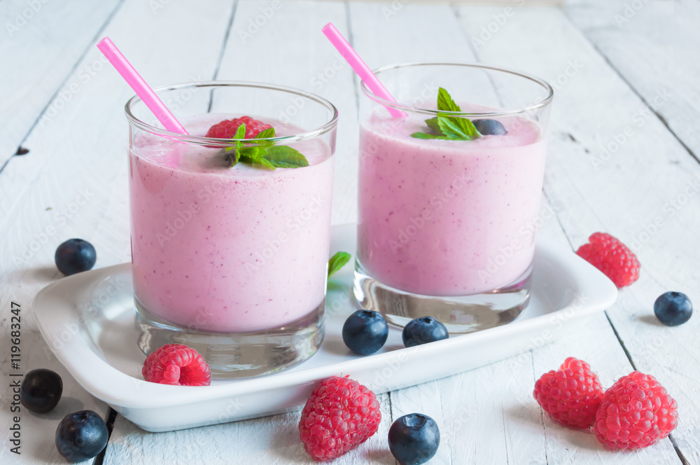 Two glasses of milkshake with fresh berries Two glasses of milkshake with fresh berries