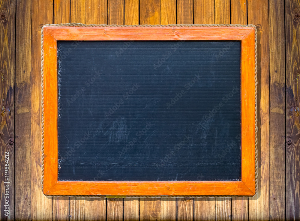 Front view of a blank blackboard over wooden surface Front view of a blank blackboard over wooden surface