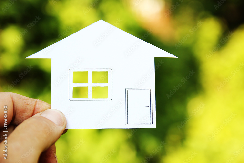 paper house in hands on a background of property paper house in hands on a background of property