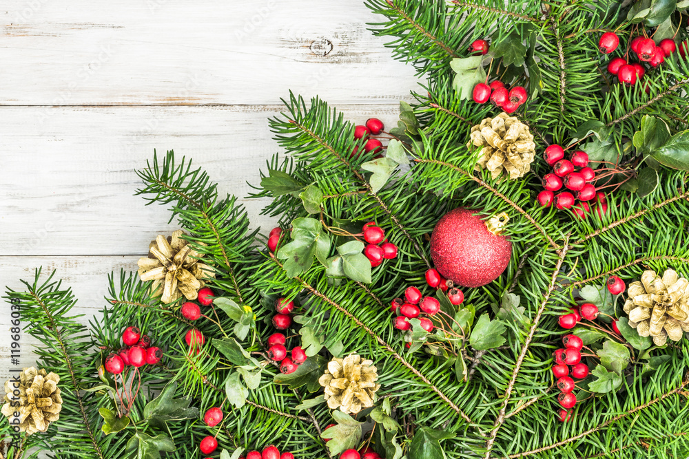 Ornamental christmas tree branch on wooden background Ornamental christmas tree branch on wooden background