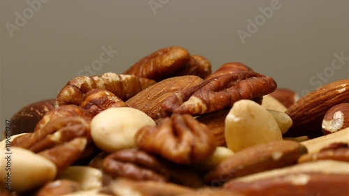Mixed nuts pile rotating in close up. Containing almonds, hazelnut, brazil nut and pecan.
