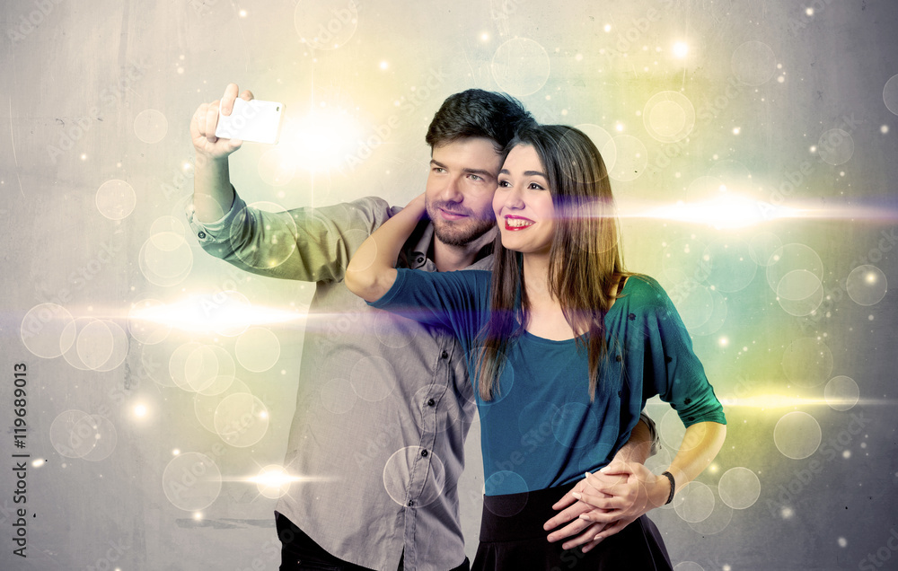 Smiling couple taking selfie in glitter light Smiling couple taking selfie in glitter light