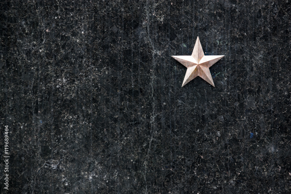gold star on a black granite surface (headstone) gold star on a black granite surface (headstone)
