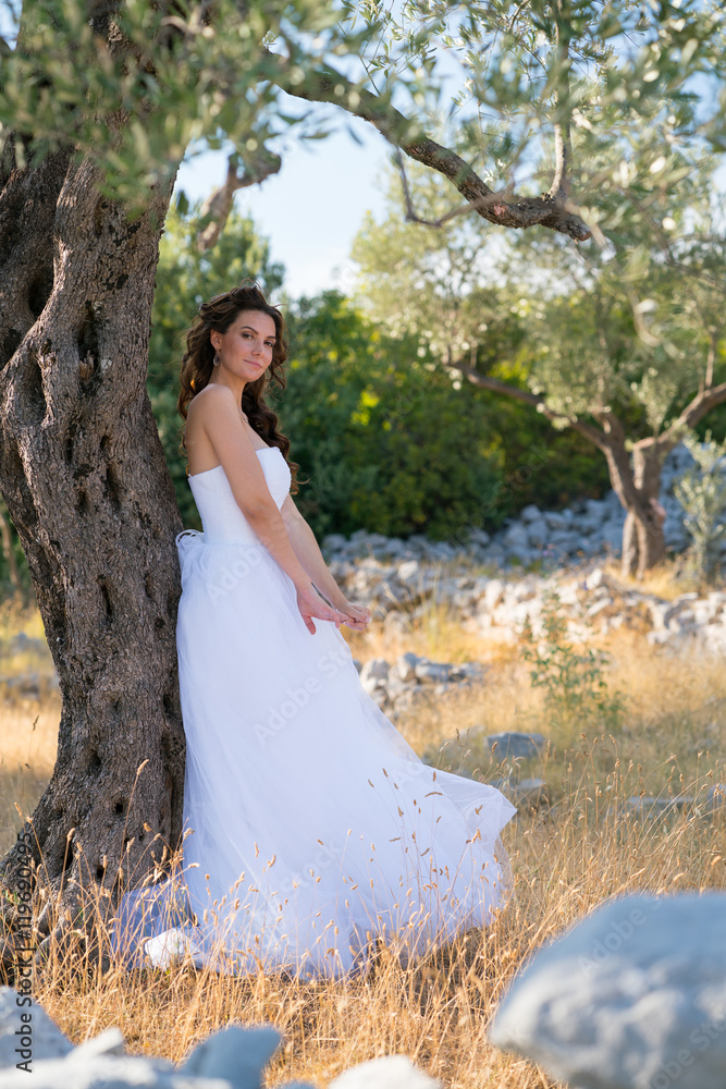 Attractive young woman enjoying her time outside in olive trees. Attractive young woman enjoying her time outside in olive trees.