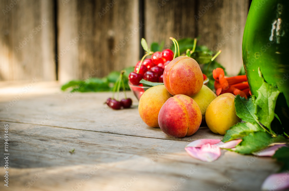 Still life of summer fruits. orange peaches, red cherries and gr Still life of summer fruits. orange peaches, red cherries and gr